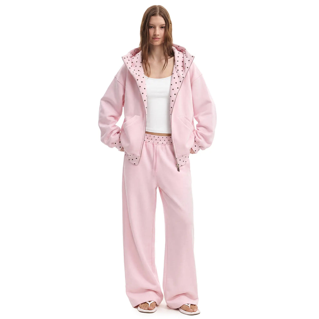 Pink polka-dot hooded matching set on female model, front view