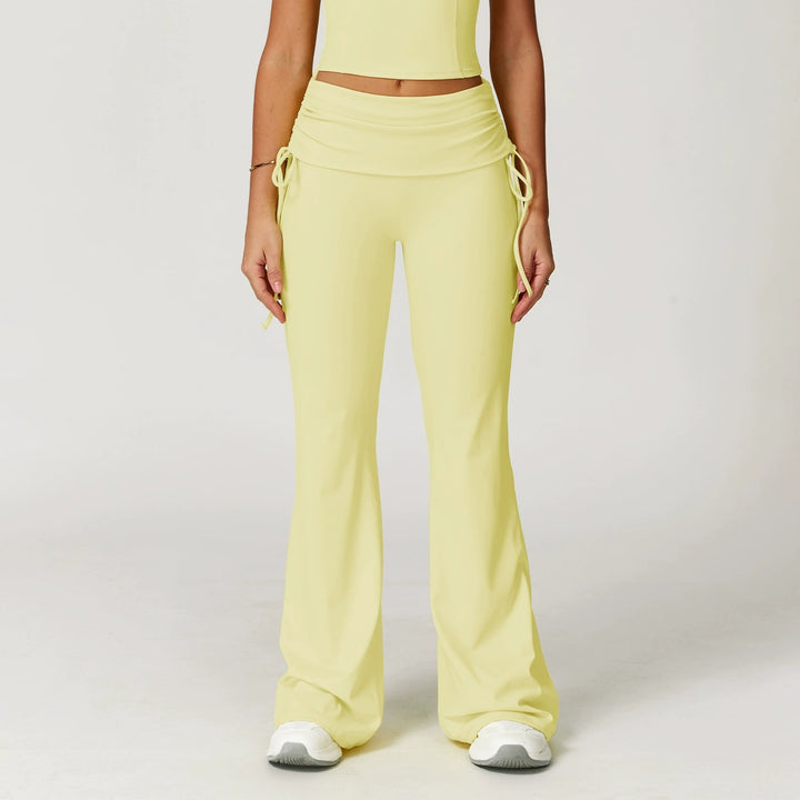 The Elara foldover high-waist flare pants in yellow front view