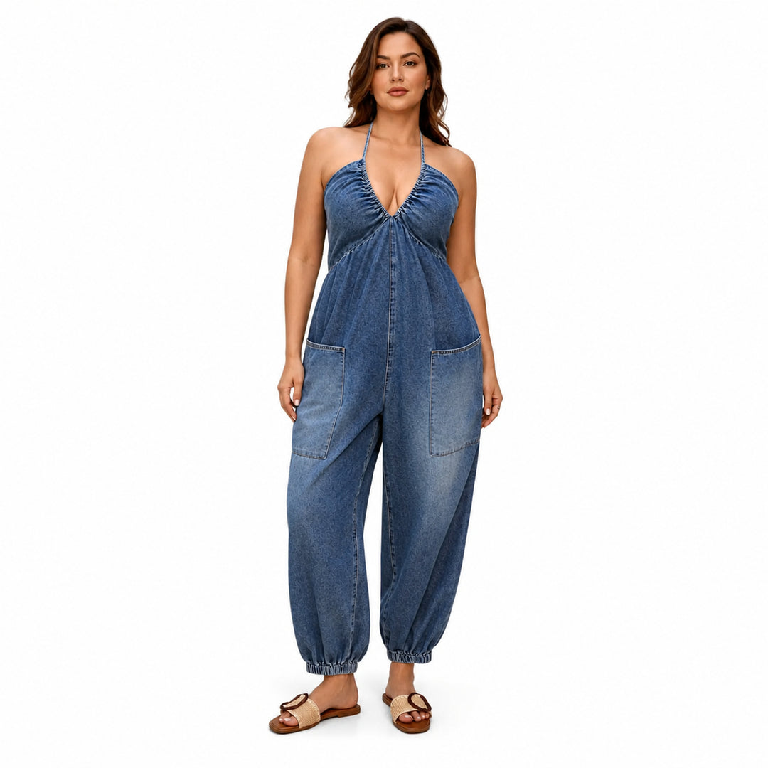 Dark blue plus-size halter denim utility jumpsuit on model, front view