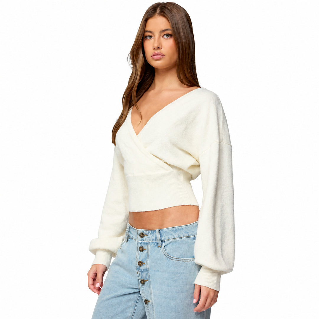 White cross-front tie-back knit sweater on model, three-quarter view