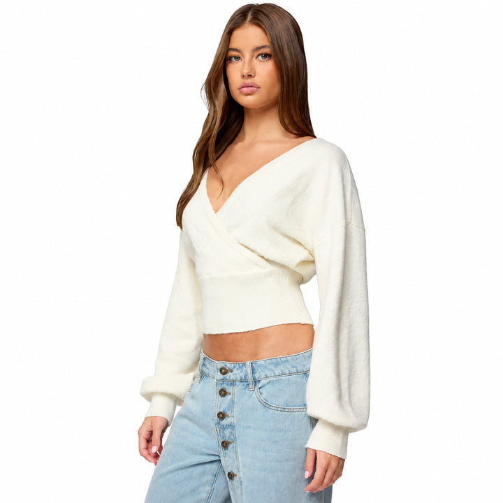 White cross-front tie-back knit sweater on model, three-quarter view