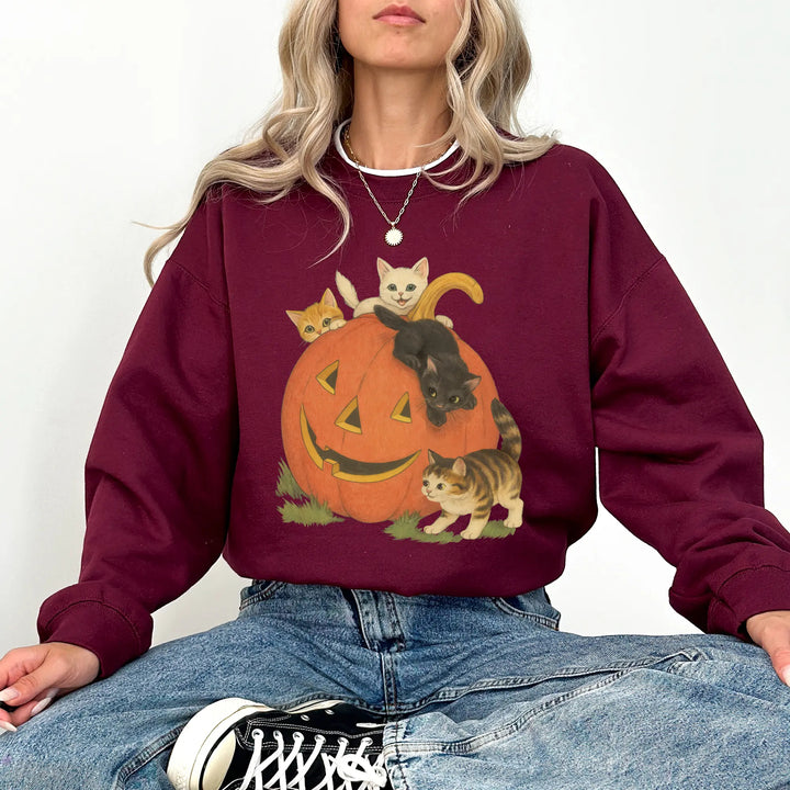 Burgundy heavyweight pumpkin cats Halloween crewneck sweatshirt on a woman