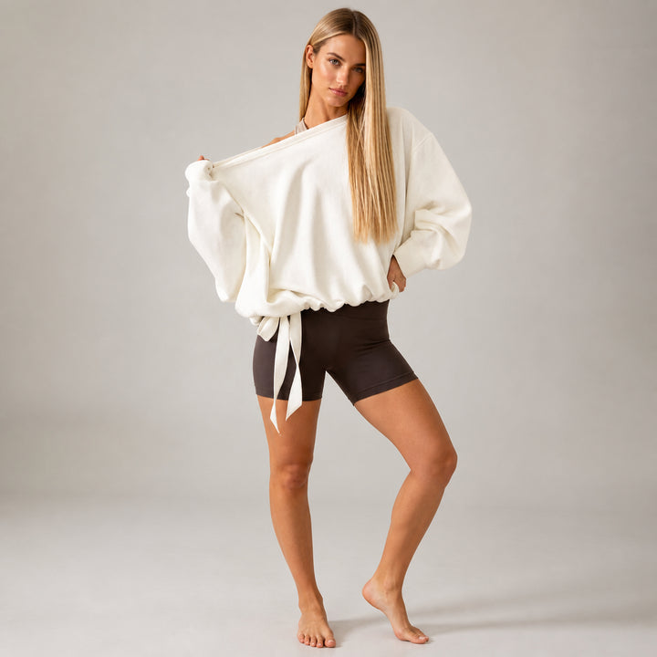 The Elara off-shoulder tie-hem sweatshirt in White