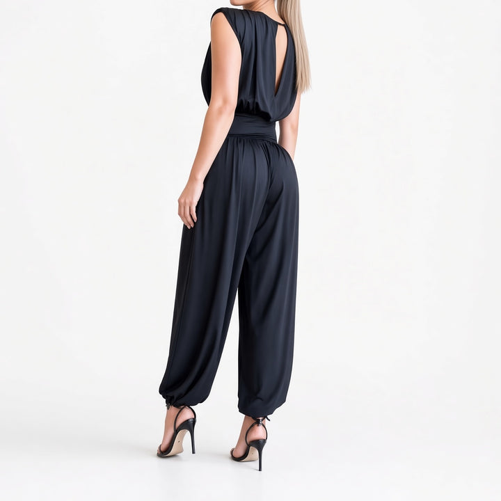 The Elara padded-shoulder harem jumpsuit in Navy, back view