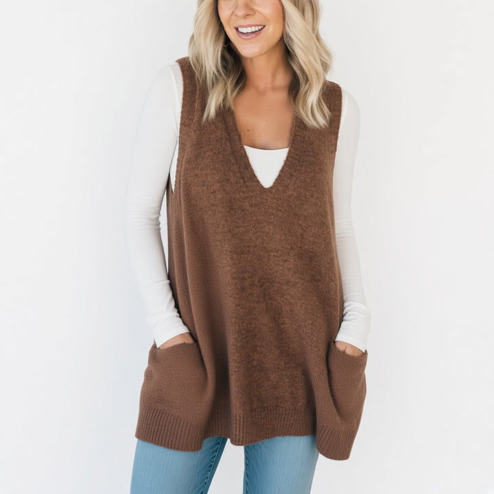Front pocket and longline drape detail on the Camel sweater vest