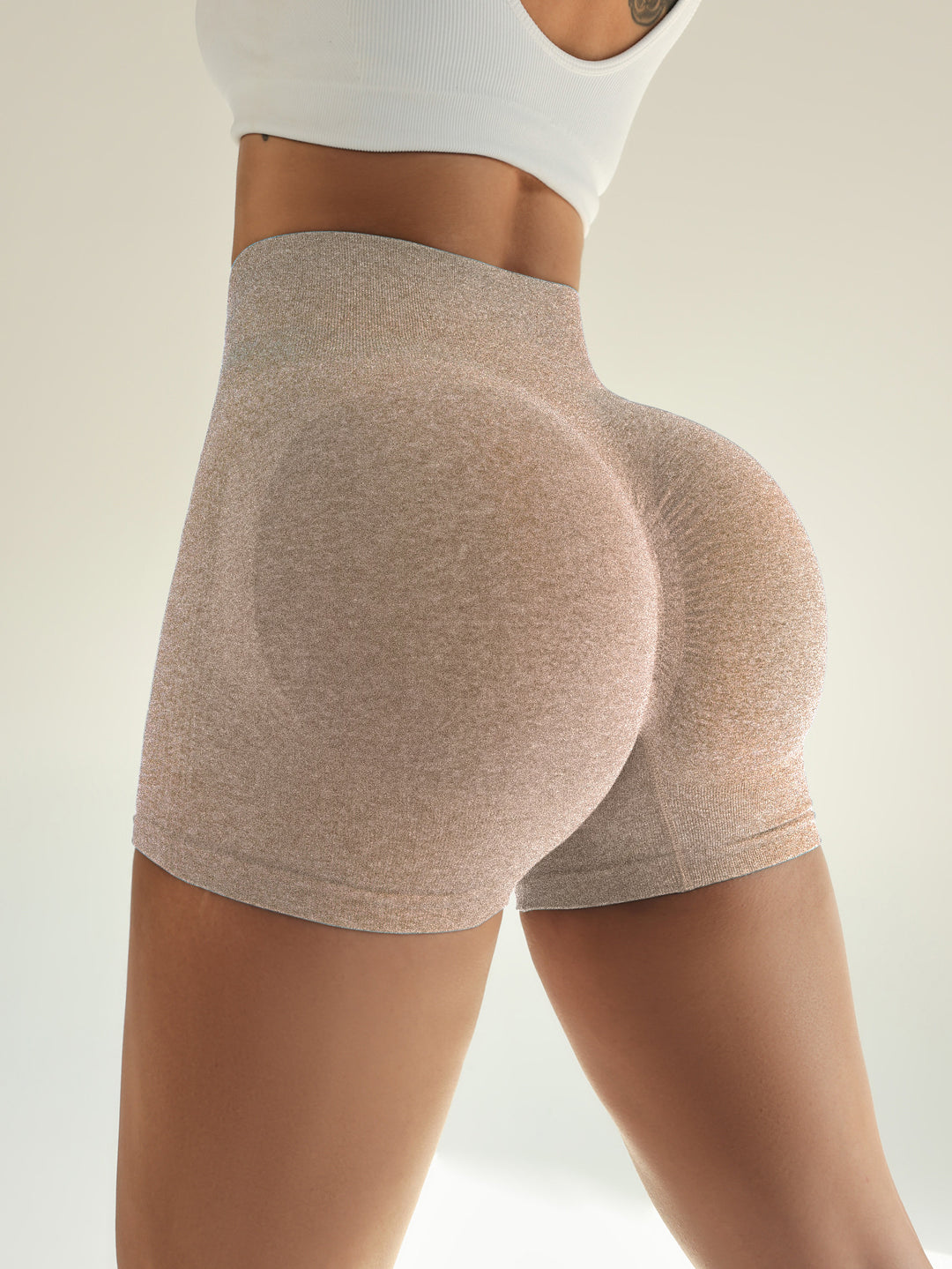 The Elara contour quick-dry yoga shorts in Heather Khaki, back view