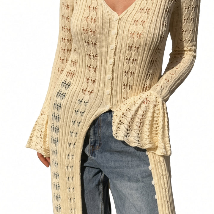Close view of the open-knit pattern and flared cuff