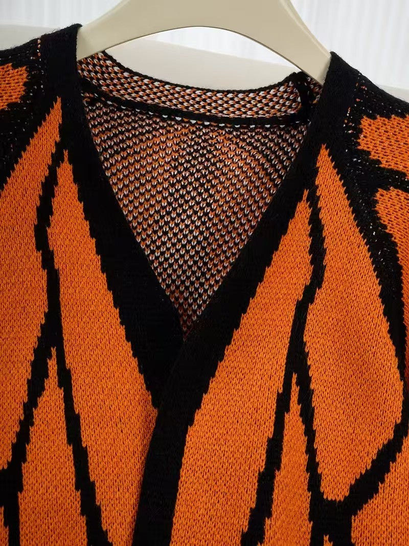 Close view of the V neckline and butterfly jacquard knit