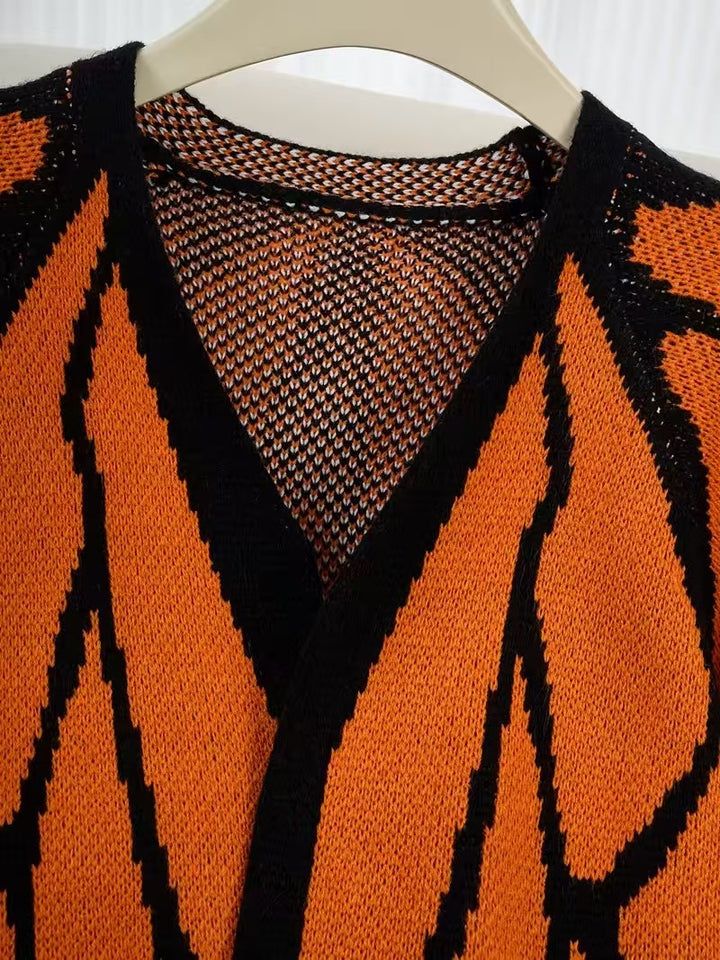 Close view of the V neckline and butterfly jacquard knit