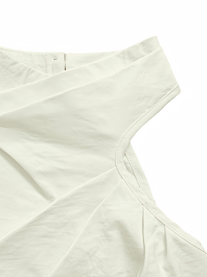 Close view of the asymmetric draped neckline on the White top