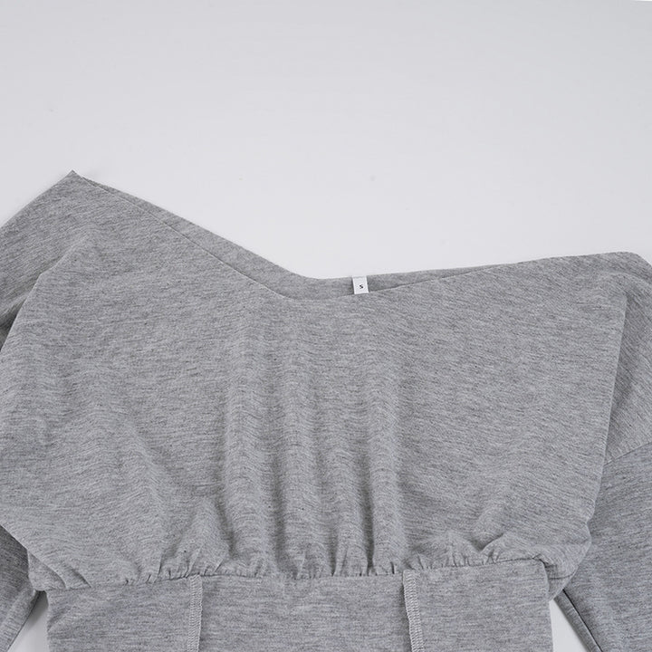 Close view of the Gray top neckline and wide cinched waist construction