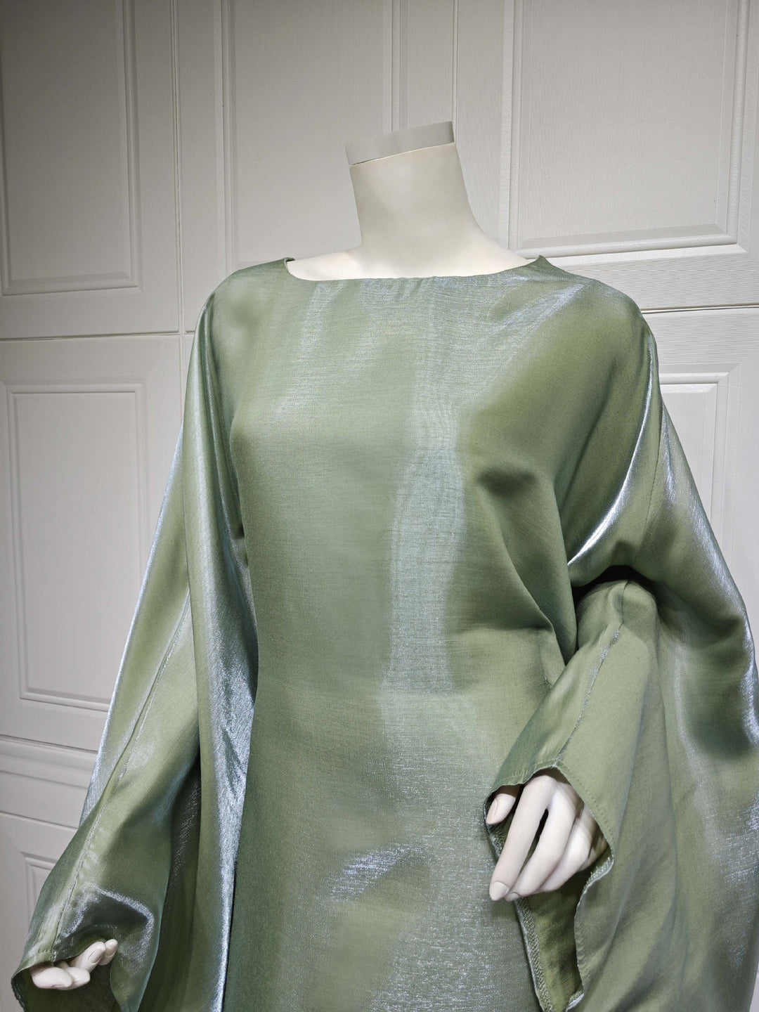Close view of the Army Green boat neckline and shimmer drape