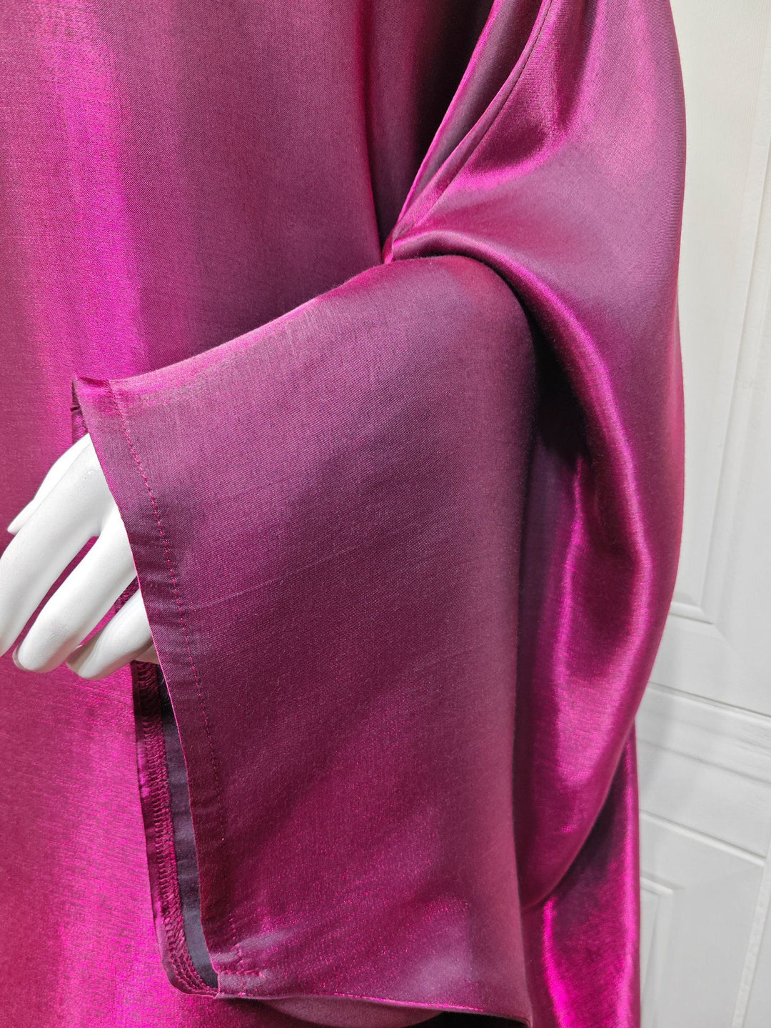 Close view of the Magenta batwing sleeve and shimmer finish