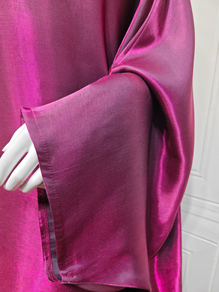 Close view of the Magenta batwing sleeve and shimmer finish
