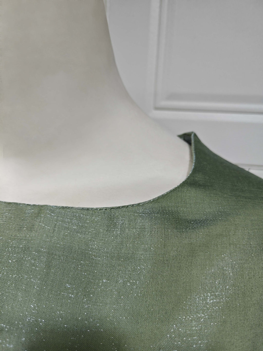 Close view of the light-catching Green shimmer fabric