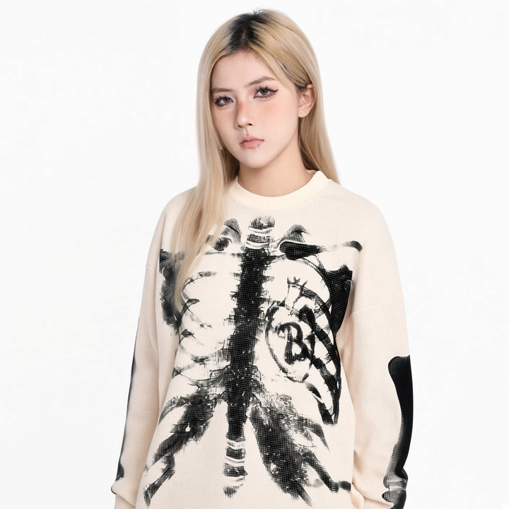 White skeleton graphic knit sweater on a woman, front view