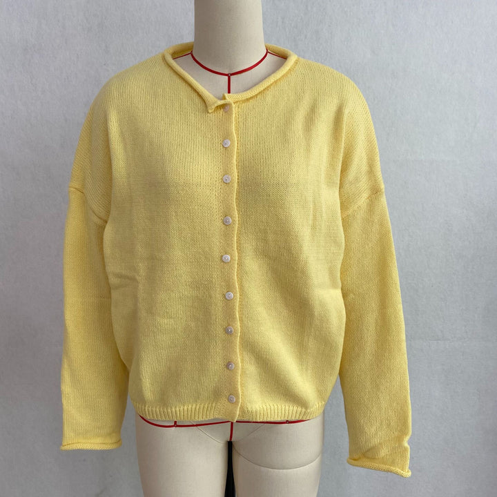 Yellow rolled-edge knit cardigan, front view on mannequin