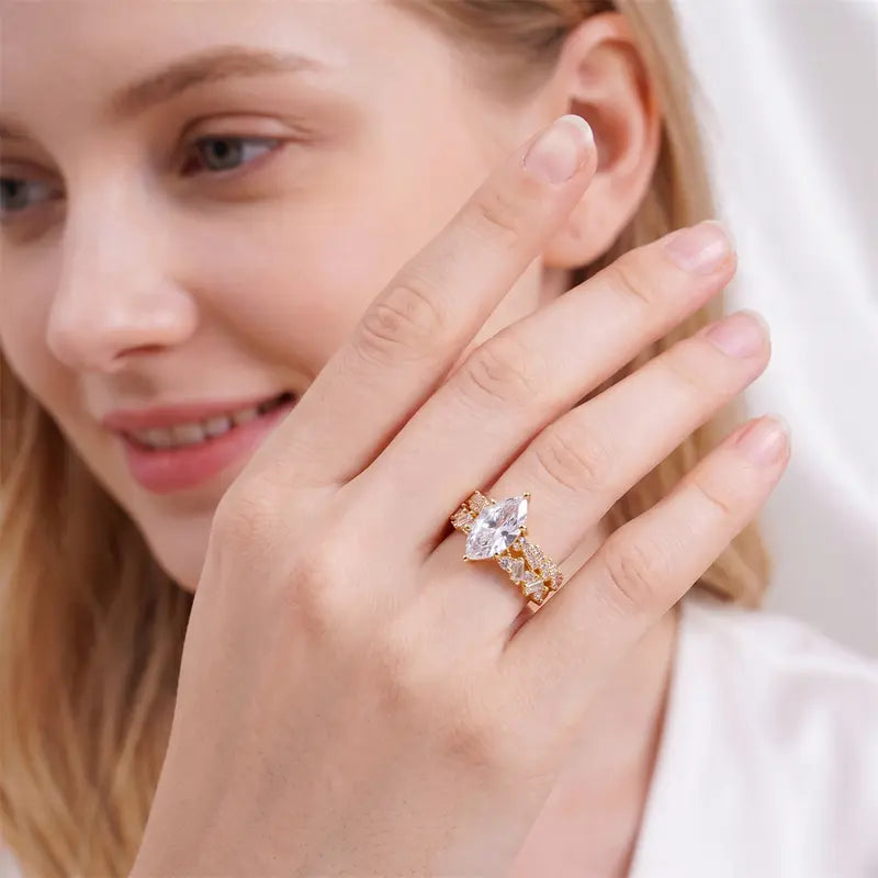 Gold-tone marquise-cut cubic zirconia ring set worn on hand