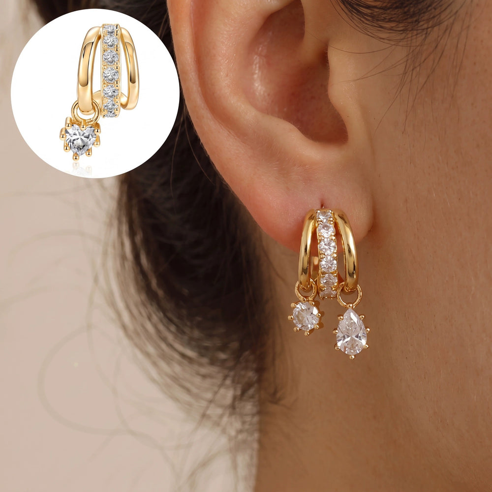 Asymmetric cubic zirconia earrings worn on ear
