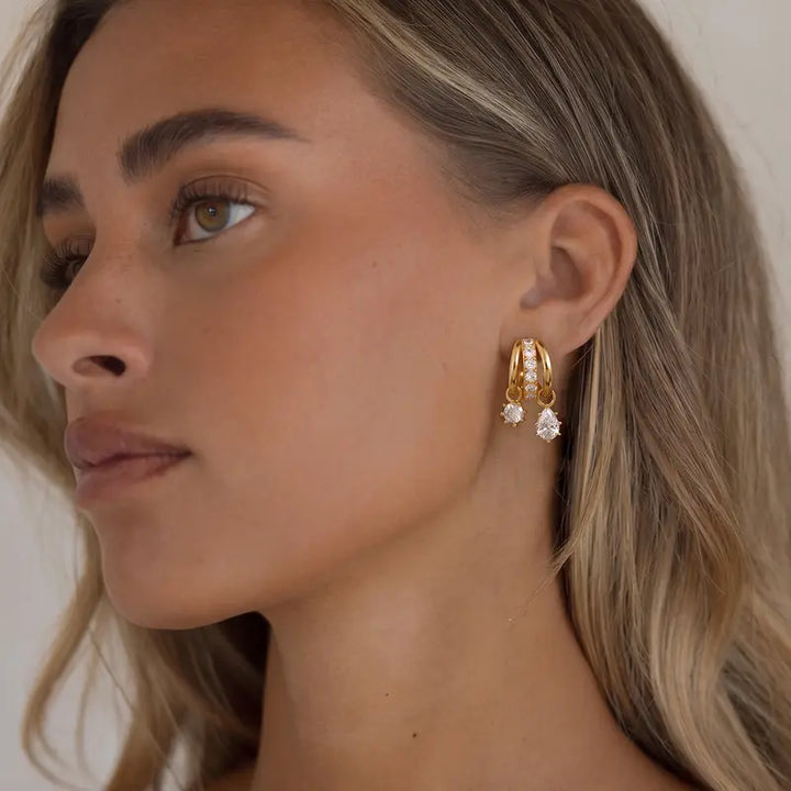 Asymmetric triple-band earrings side view on model