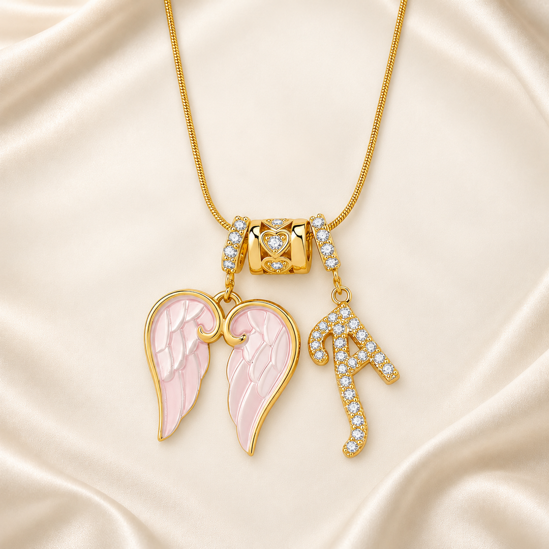 Letter A wing initial pendant necklace on warm cream satin