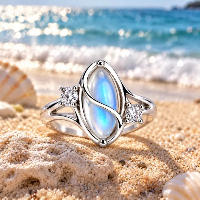 Moonstone ring displayed on beach sand