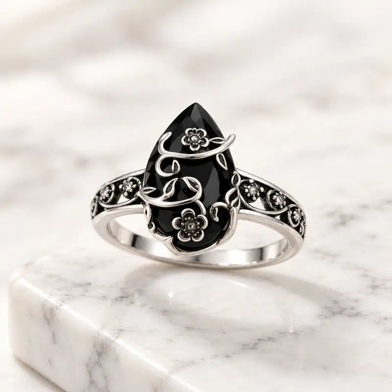 Floral cat ring displayed on marble