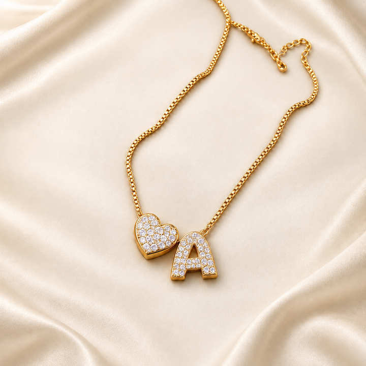 Personalized gold heart initial necklace on warm cream satin