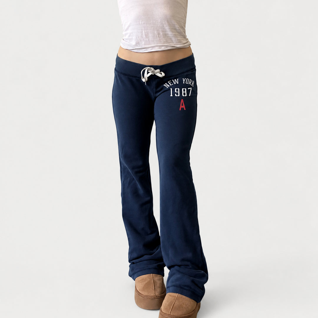The Elara Low-Rise Graphic Drawstring Flare Pants in Navy, front view