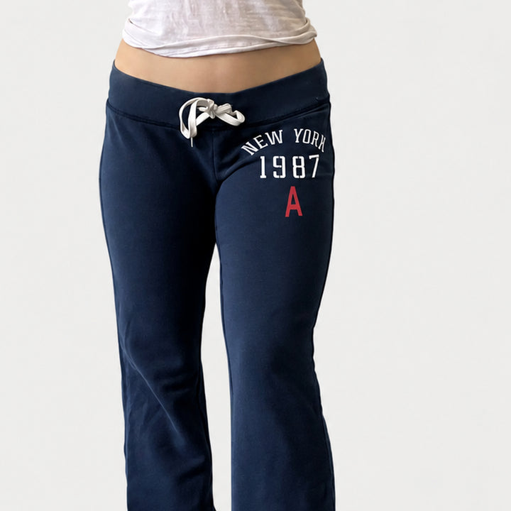 Navy drawstring waistband and collegiate graphic detail