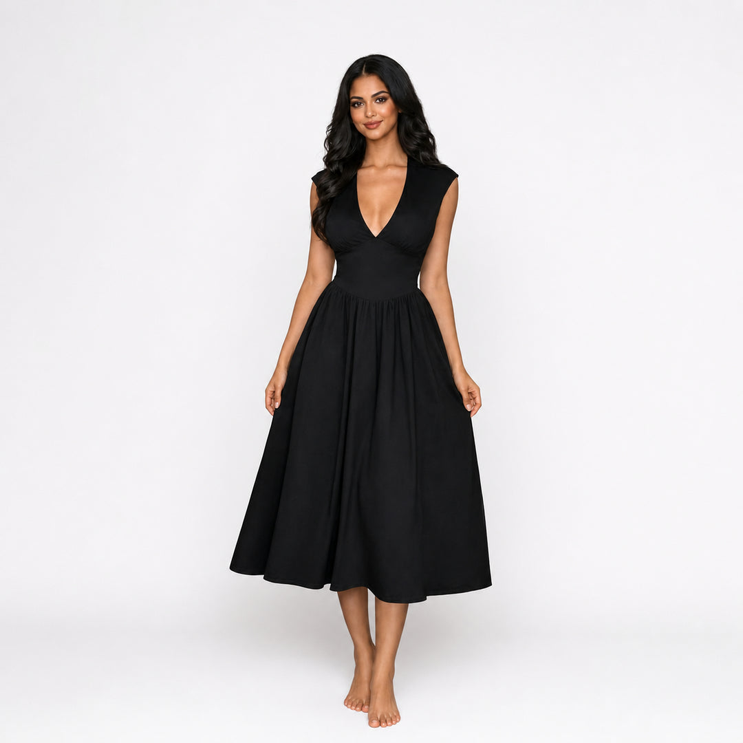 Black padded-shoulder tie-back midi dress on female model, studio front view