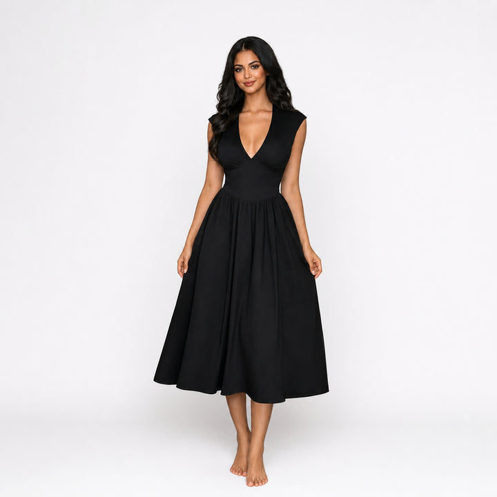 Black padded-shoulder tie-back midi dress on female model, studio front view