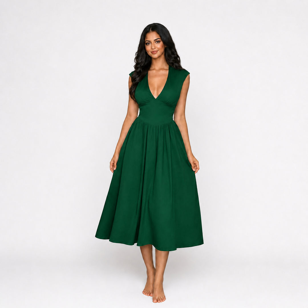 Green padded-shoulder tie-back midi dress on female model, studio front view