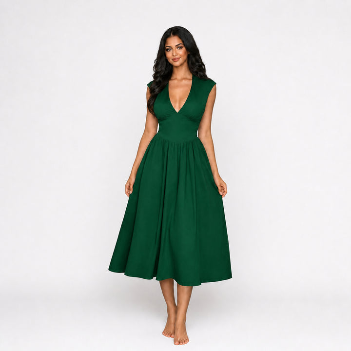 Green padded-shoulder tie-back midi dress on female model, studio front view