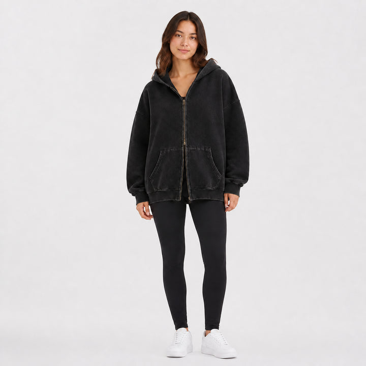 Black oversized double-zip hoodie on female model, studio front view