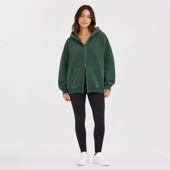 Green oversized double-zip hoodie on female model, studio front view