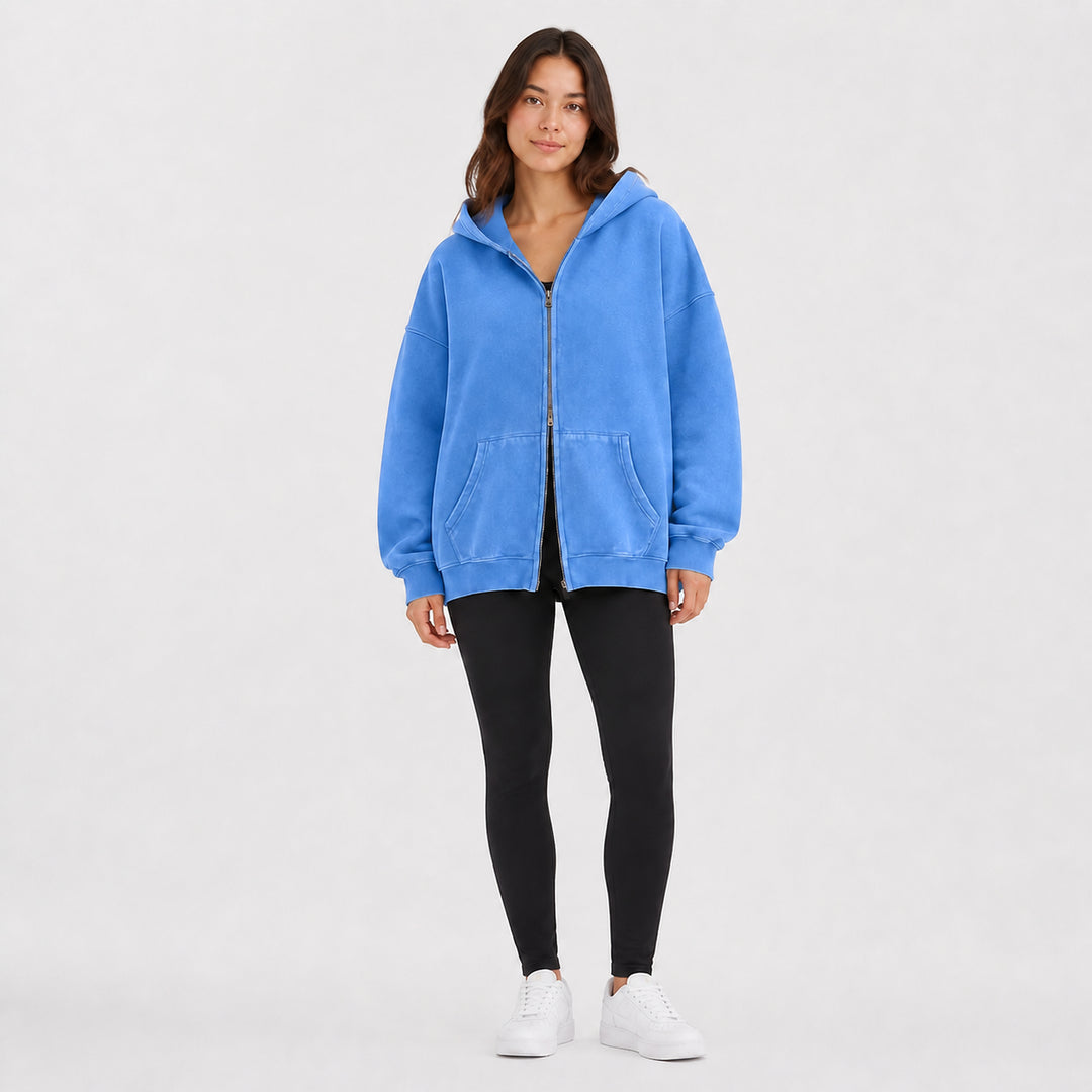 Blue oversized double-zip hoodie on female model, studio front view