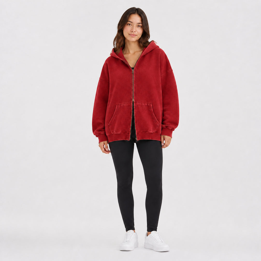 Brick red oversized double-zip hoodie on female model, studio front view