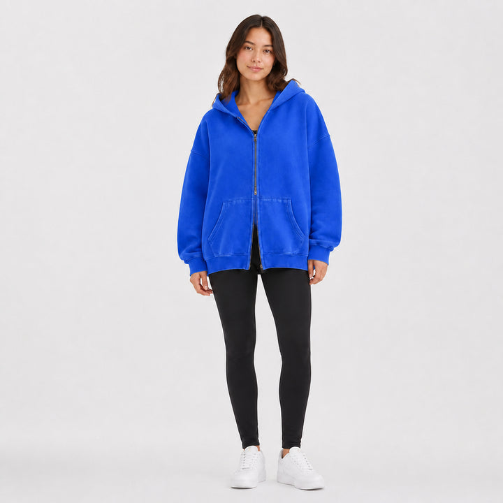 Deep blue oversized double-zip hoodie on female model, studio front view