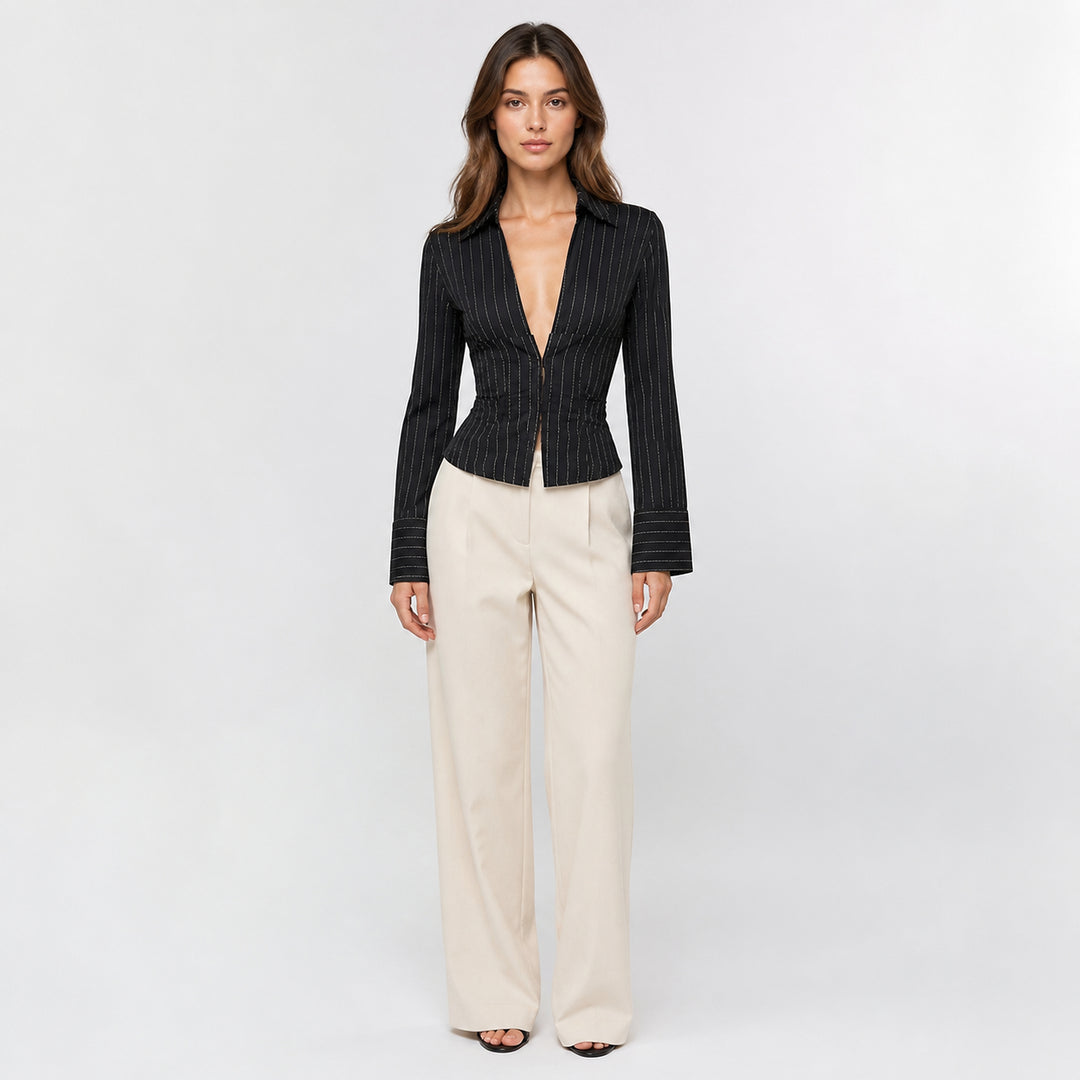 Black hook-front striped blouse on female model, studio front view