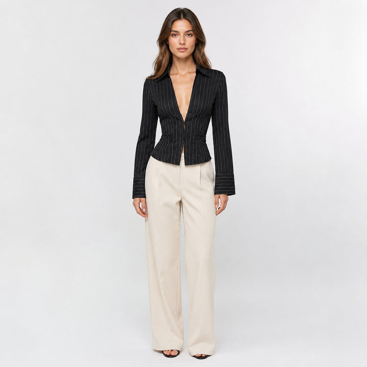 Black hook-front striped blouse on female model, studio front view