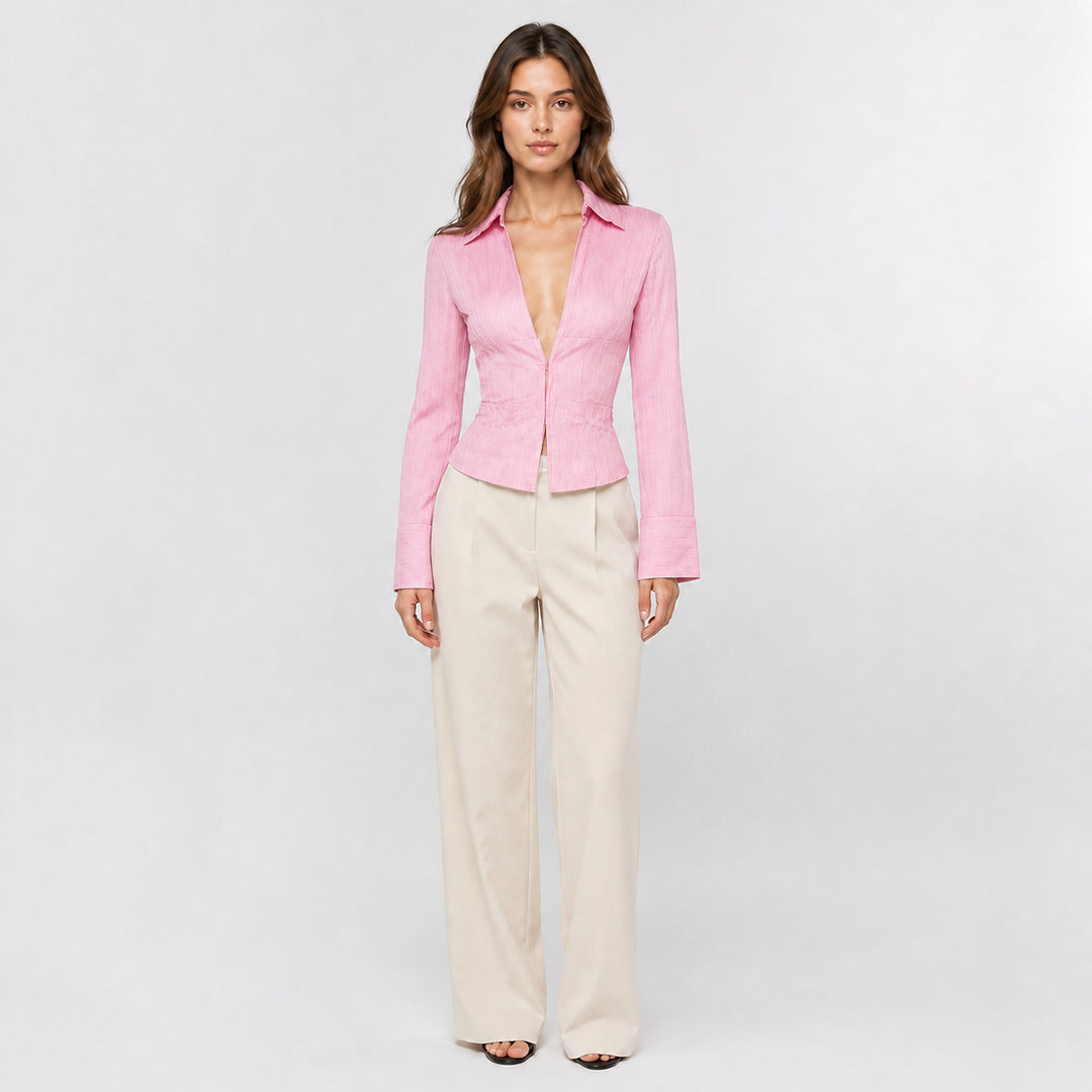 Pink hook-front striped blouse on female model, studio front view